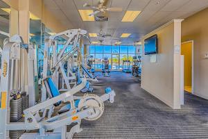 a gym with treadmills and machines in a building at The Wharf 805 in Orange Beach