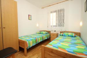 a bedroom with two beds and a window at Apartments with parking space Pag - 6535 in Pag