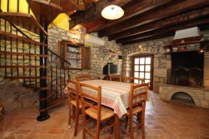 a dining room with a table and chairs and a fireplace at Holiday house with a swimming pool Krsan - Vlasici, Central Istria - Sredisnja Istra - 7686 in Kršan