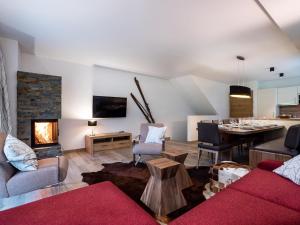 a living room with a couch and a fireplace at Chalet Anna XL Leogang in Leogang