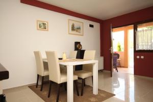 a dining room with a white table and chairs at Apartments with a parking space Valbandon, Fazana - 2214 in Fondole +13 photos