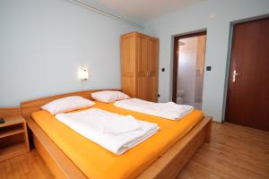a bedroom with two beds with white sheets at Double Room Peroj 2235c in Peroj