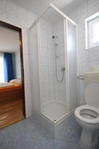 a bathroom with a shower and a toilet at Double Room Peroj 2235c in Peroj