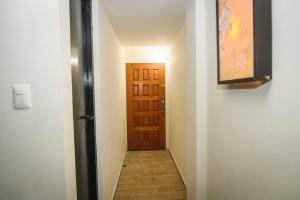 pasillo con puerta marrón y suelo de madera en habitacion, tipo hotel 4 personas aire acond, independiente, nuevo TV smart 60 pulgadas D9, en Ciudad Valles