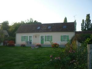 a white house with green shutters and a yard at Ancien corps de ferme restauré avec jardin clos, proche A11, 3 chambres, barbecue, calme garanti - FR-1-410-343 in Le Bailleul