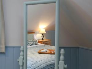 a bedroom with a bed with a tray of food on it at Sawmill Cottage in Royal Tunbridge Wells