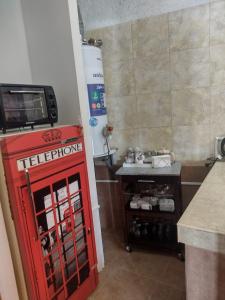 a red lego machine in a kitchen next to a counter at Rincón Spa Seule in Ciudad Lujan de Cuyo