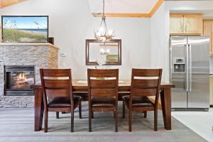 a kitchen with a table and chairs and a fireplace at Modern Condo - EV Plug In - SM 301 in Bear Valley +32 photos