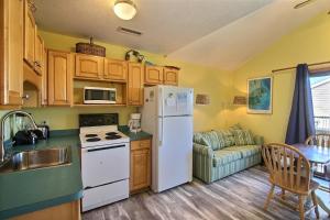 a kitchen with a white refrigerator and a table at NC 12 56821-28 Condo in Hatteras