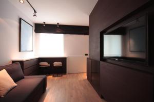a living room with a couch and a flat screen tv at Modern Studio Apartments Old Town-Kazimierz in Krakow