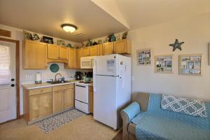 a kitchen with a white refrigerator and a couch at NC 12 56821-16 Condo in Hatteras