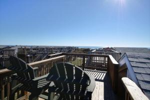 a deck with chairs and a view of the ocean at NC 12 56821-16 Condo in Hatteras