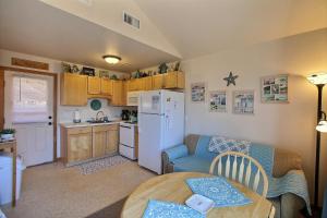 a small kitchen with a white refrigerator and a table at NC 12 56821-16 Condo in Hatteras
