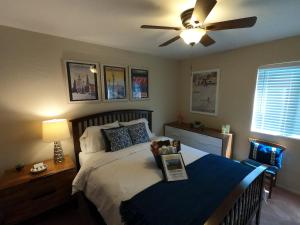 a bedroom with a bed with a ceiling fan at Sommer Hus-Best value in Southern California Wine Country in Temecula