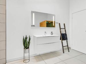 a white bathroom with a sink and a mirror at Modern Retreat in Graerup - By Traum Ferienwohnungen in Oksbøl +64 photos