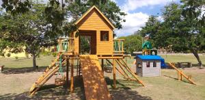 a playground with a small wooden play structure at Winterville Flat 905 in Gravatá