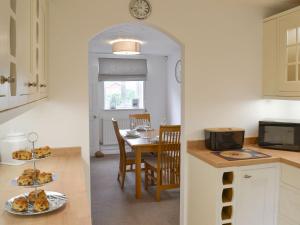 a kitchen with a table with plates of food on it at The Tides - E5327 in West Bay