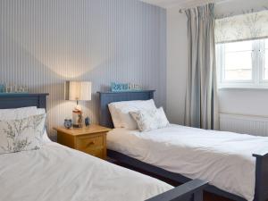 a bedroom with two beds and a window at The Tides - E5327 in West Bay