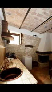 a kitchen with a sink and a fireplace in it at Il Minotauro B&B a 5 minuti da Popoli in Vittorito +62 photos