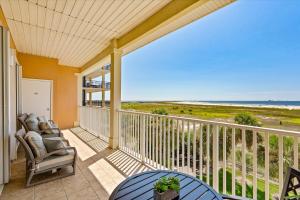 a balcony with a view of the beach at The Pelican Place - Amazing Views, Top Floor Condo in Dauphin Island