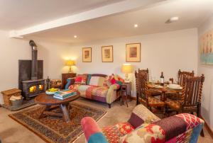 a living room with a couch and a table at Southcott Farm Cottage in Honiton