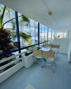 a balcony with a table and chairs in a building at Kassavetis Center - Hotel Studios & Apartments in Hersonissos