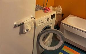 a washer and dryer in a bathroom with a sink at 2 Bedroom Cozy Home In Virsbo in Virsbo Bruk