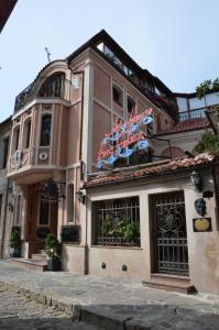 a building with flags on the front of it at Boutique Hotel Boris Palace & Restaurant in Plovdiv