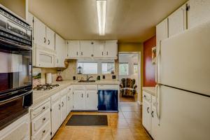 a kitchen with white cabinets and a refrigerator at Pine Tree Place - Unit 7 in South Lake Tahoe