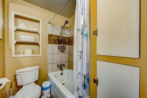 a bathroom with a toilet and a tub and a shower at Pine Tree Place - Unit 7 in South Lake Tahoe
