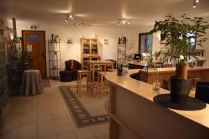 a living room with a counter with a potted plant at Hôtel Les Charmilles de Mormal in Landrecies