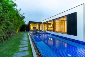 a swimming pool in the backyard of a house at Villoft Zen Living Resort in Bang Tao Beach +56 photos