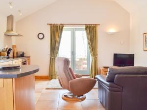 a living room with a couch and a chair at The Wests in Lastingham