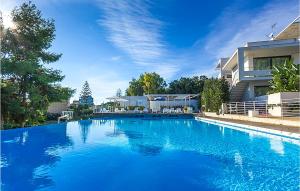 ein großer blauer Swimmingpool vor einem Haus in der Unterkunft Nice Home In Marina Di Ragusa With Wifi in Marina di Ragusa