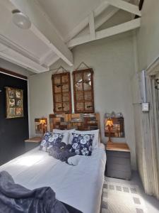 a bedroom with a large white bed with blue pillows at SomethingElz@Grace in Pretoria