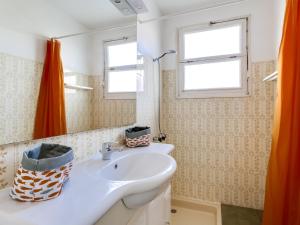 a bathroom with a sink and a mirror at Villa T4 à Biscarrosse Plage, jardin privé, WiFi, 50m de la plage, 6 personnes - FR-1-521-150 in Biscarrosse +7 photos