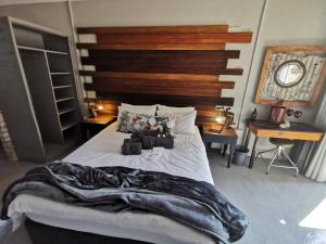 a bedroom with a bed with a blanket on it at SomethingElz@Grace in Pretoria
