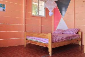 a wooden bench with purple cushions in a room at Private Over-Water Cabin on paradise San Blas island in Waisalatupo