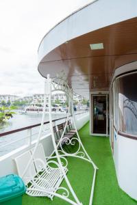 a balcony on a cruise ship with green grass at Halong Bay Full Day Trip - 6 Hours Route in Ha Long