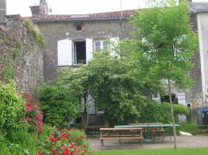 una casa con un tavolo da picnic di fronte di B&B "Les Remparts" a Vouvant