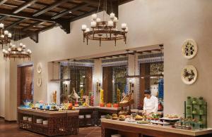 a chef in a kitchen preparing food in a restaurant at Sawai Man Mahal in Jaipur