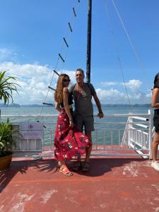 a man and a woman standing on a boat at AROMA Ha Long Hotel in Ha Long