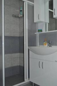 a bathroom with a shower and a sink at T&A Apartments in Ohrid