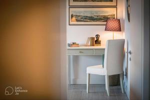 a desk with a chair and a lamp on it at Lakeview Panorama Penthouse with Washer & Dryer in Lugano