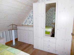 a bedroom with a mirror and a bed in a attic at Ruegen_Fewo 19 in Ummanz