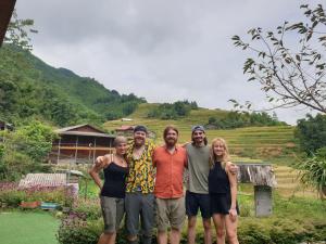a group of people standing in front of a hill at Sapa Eco Hugo in Sa Pa