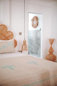 a bedroom with a bed and a window at VILLA LA ISLA BONITA walking distance to the beach in Gili Air