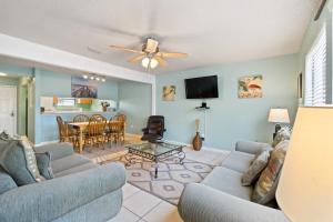 a living room with two couches and a dining room at Sugar Beach D17 in Navarre