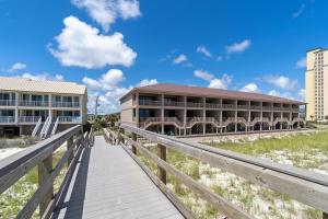 a boardwalk leading to a building on the beach at Sugar Beach D17 in Navarre