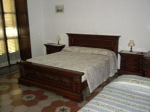 a bedroom with a large bed and two night stands at Il Tiglio in Cavagnolo